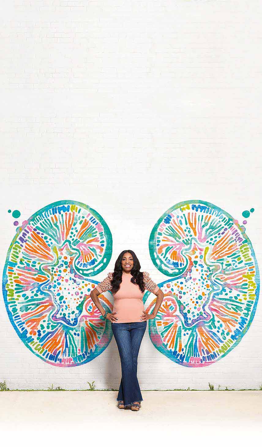 Malisha, a person taking LUPKYNIS, standing in front of a kidney mural